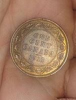 Reverse side of the 1911 Canada one cent large cent coin displaying denomination and maple leaf wreath design.