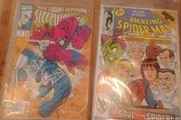 Photo showing two comic books: Sleepwalker featuring Darkhawk on the left and Amazing Spider-Man issue 273 on the right, each in plastic protective covers.