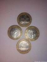 Four 10 franc coins arranged showing reverse sides with 'RF' and walking figure on two coins, highlighting bi-metallic composition and design details.