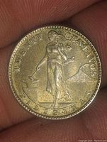 Obverse of 1944 Philippines 20 Centavos coin showing a woman striking an anvil with Mount Mayon volcano in the background and inscriptions.