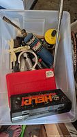 Tote with propane cylinder, MAP-Pro cylinder, ratchet bar, red tool case, black HELI case and misc small tools
