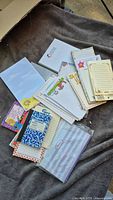 Spread of assorted notepads displayed on blanket