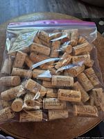 Bag of roughly 50 assorted used wine corks with various winery imprints