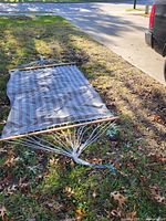 Full view of hammock laid on grass