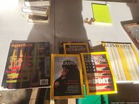 Group of five magazines: three National Geographic, one Blind Spot, one Aperture
