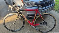 Full side view of Raleigh Six Hundred road bicycle in front of car
