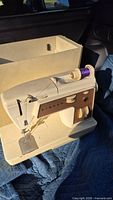 Singer Touch & Sew II sewing machine with case lid removed, showing spool pin and control panel