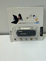 Black 256GB USB Flash Drive in original retail packaging, showing front graphics and device details.