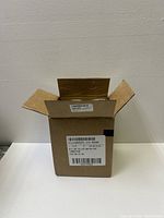 Open shipping box showing labeling and packaging for hand sanitizer bottles.