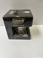 Front and side of original box for Coleman 1900 Collection Lantern showing brand, model, and some specs.