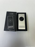 Front view showing translator device and packaging with product branding