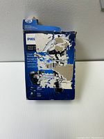 Damaged product box with heavy wear and tear, showing Philips branding and product info.