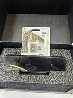 Raven backup camera and Samsung 64GB microSD card set in foam packaging, viewed from front and top angles