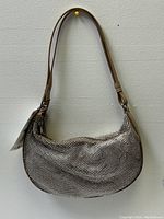 Front view of medium size Zara handbag showing silver rhinestone mesh body and tan strap.