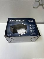 Box of black commercial thermal label printer for 4x6 labels with product features.