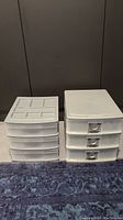 Photo of two sets of white plastic office storage units, one with four drawers and metal label holders, and one with three drawers and a compartmentalized top