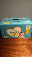 Box of Pampers Swaddlers diapers, size 2, 84 count, unopened and new condition.