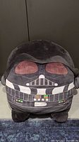 Front view of Star Wars Darth Vader Squishmallow showing detailed printed helmet and chest panel graphics on soft plush fabric.