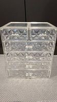 Front view of clear acrylic vanity organizer with five drawers.