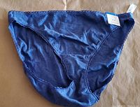 Front view of women's bikini style underwear in galaxy blue with scalloped trim and tags attached.