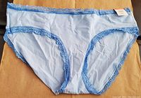Front view of light blue hipster underwear with lace trim along edges showing the body fabric and lace detail.