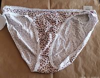Front view of one bikini bottom with wild leopard print and lace trim, tag visible