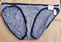 Photo of front side of Jenni Women's bikini bottom with navy thin stripes and scalloped edges, size tag attached.