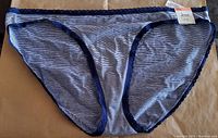 Front view of Jenni bikini bottom with thin navy and white stripes and navy edging, new with tags visible.