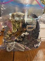 Ziploc plastic bag filled with assorted bejeweled hair clips in various colors and styles.