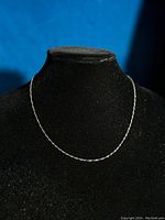 Twisted rope chain displayed on black bust to show overall design and drape