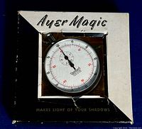 Stopwatch visible through clear window in retail box labeled 'Ayer Magic' and 'Makes Light of Your Shadows'