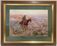Full view of framed print showing Western scene with cowboy on horse overseeing a herd and covered wagons. Frame is wooden with gold accent and green matte.