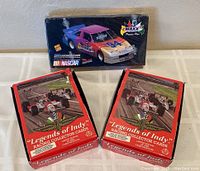 One sealed box of 1994 Maxx Premium Plus set with colorful NASCAR race car image, plus two red 1992 Legends of Indy Racing boxes shown together