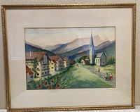 Framed watercolor landscape showing entire painting and frame reflecting light