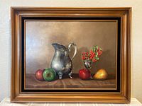 Full view of framed oil painting featuring pewter pitcher, fruit, and silver vase with berries on neutral background