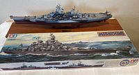Completed and painted USS Missouri 1/350 scale model mounted on wood base, placed with original box in front showing kit artwork and branding.