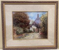 Framed offset print showing a cottage pathway and figure in garden with ornate gilt wood frame and cream matte border.