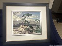 Front view of framed print “The White Pine” by A.J. Casson in black wood frame with double mat.