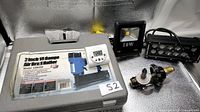 All items grouped: nailer case, LED floodlight, LED light bar, digital timer, helium valve