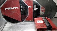 Two packaged Hilti 14" diamond blades, one abrasive wheel and tune-up kit box