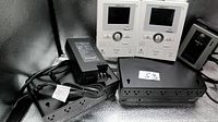 Front view of two Aiphone monitors, APC UPS units, Aiphone power adapter and door station