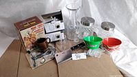 Overview showing all items including boxed mug tree, boxed espresso cups, utensils, jars, bowls and cleaver