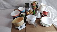 Group shot showing entire assortment of bowls, mugs, casseroles, pitcher and beaters