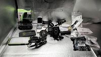 Overview of entire lot showing phones, chargers, cases, power bar and accessories