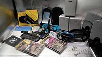 Overall lot showing speakers, PSP accessories, headset and manuals