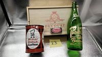 Front view showing Mister Donut coffee tin, Ducourt wine box, Punch glass bottle