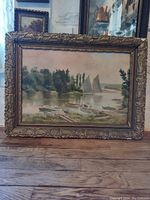 Full view of the framed impressionist oil painting showing the dock, children, boats, trees and water in a scenic composition.