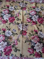 Full view of bright yellow barkcloth fabric with large pink, white, and tan floral pattern on textured fabric.