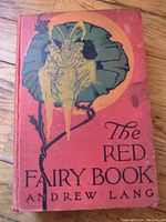Front cover of 'The Red Fairy Book' showing artwork and title with visible age wear.