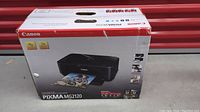 Box showing the Canon Pixma MG2120 printer image and branding, including photo printing capability